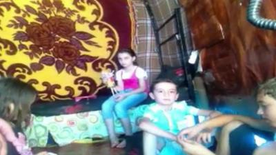 Mahmoud's family inside the container that it their home