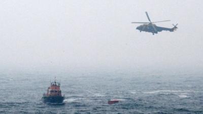 Resscue Helicopter and Lifeboat reaching a life raft