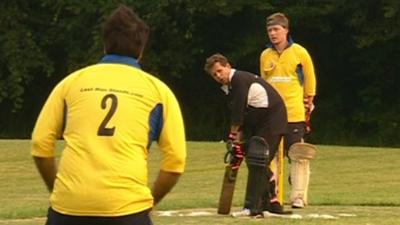 Mike Bushell with a cricket bat