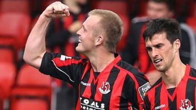 Jordan Owens celebrates scoring against Linfield