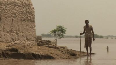 A man stranded by flood water