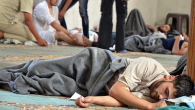 A survivor from what activists say is a gas attack rests inside a mosque in the Duma neighbourhood of Damascus (21 August 2013)