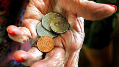 Elderly woman holding money