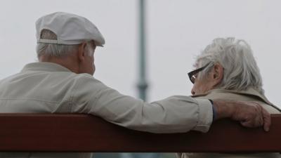 Retired couple on bench