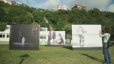 Photographs displayed on a lawn in Getxo