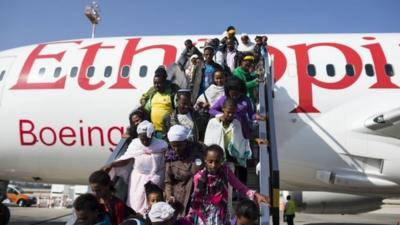 New Jewish immigrants walking down the airplane during a welcoming ceremony after arriving on a flight from Ethiopia