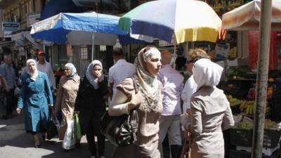 Syrians shop at al-Shaalan market in Damascus August 28, 2013