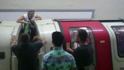 Woman climbs out of a Tube window