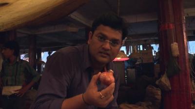 BBC's Nitin Srivastava holding onion