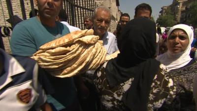 People in Damascus queue for bread