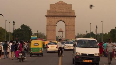 A busy street in Delhi, leading up to the India Gate