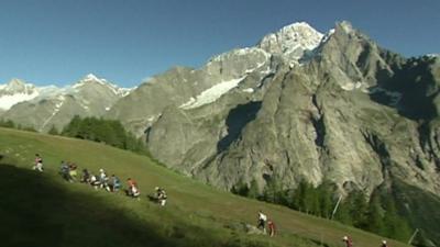 Competitors hike through mountains close to Mont Blanc