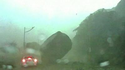 Giant boulder lands near car