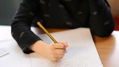 Child writing on notepad