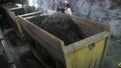 Big skips inside a mine containing earth.