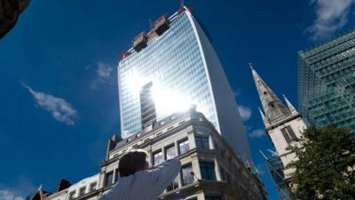 Man reacts to sunlight bounces off the 'walkie talkie' building in London