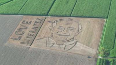 The portrait of Pope Francis ploughed into a field