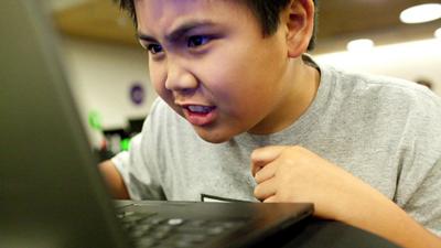 A young person playing Re-Mission 2