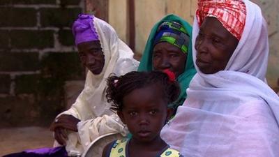 Gambian female circumcisers and child