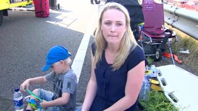 Woman on roadside with son