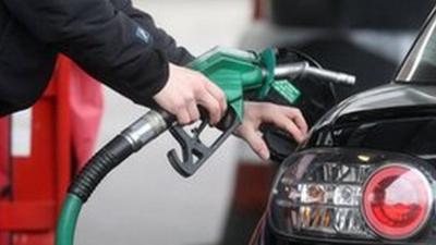 Person filling car at petrol pump