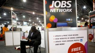 A job-seeker completes an application at a career fair