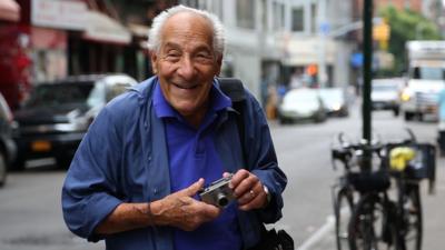 Victor Friedman on the street with his camera