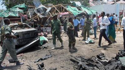 Somali soldiers gather near The Village restaurant following blast