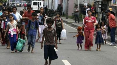 Residents flee from fighting between security forces and rebels from the Moro National Liberation Front (MNLF) who raided several villages in Zamboanga city