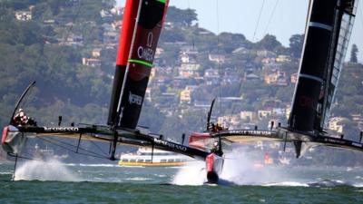 Team New Zealand (l) and Oracle Team USA contest America's Cup