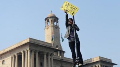 In December 2012, an Indian demonstrator holds up a sign during a protest in front of the Government Secretariat and Presidential Palace in New Delhi, calling for better safety for women following the rape of a student in the Indian capital