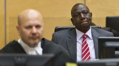 Kenya"s Deputy President William Ruto (R) reacts as he sits in the courtroom before his trial at the International Criminal Court (ICC) in The Hague September 10, 2013.