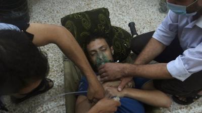 A man, affected by what activists say is nerve gas, breathes through an oxygen mask in the Damascus suburb of Jesreen August 21, 2013