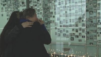 tearful relatives look at photos of lost loved ones