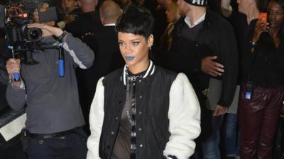 Rihanna poses at the launch of her new fashion collection in London