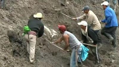 Rescue crew dig into debris caused by the mudslide