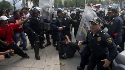 Teachers and police clash during a protest