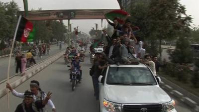 Fans on motorbikes and on the back of cars celebrate