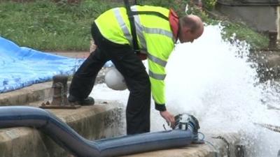 Environment Agency officer tests defences