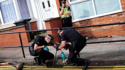 Police making a search near to the scene of a house fire at Wood Hill, in the Spinney Hills area of Leicester, which claimed the lives of four people