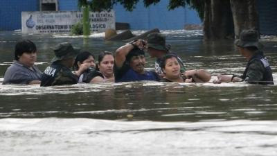 People chest-deep in flood water in Villahermosa, Mexico