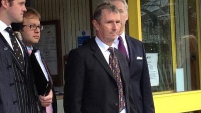 Nigel Evans (centre) wearing a dark suit