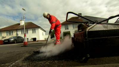 Pot hole being mended