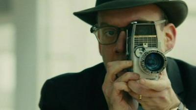 Actor Paul Giamatti as Abraham Zapruder with movie camera