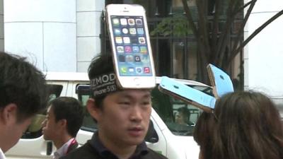 A man with an iPhone on his forehead