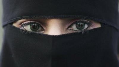 A young Muslim woman wearing a niqab.