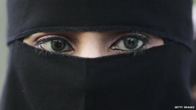 A young Muslim woman wearing a niqab.