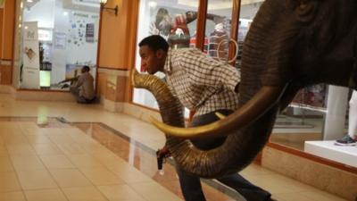 Armed police search through Westgate shopping centre for gunmen in Nairobi, September 21, 2013