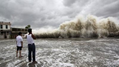 People watching huge wave approach