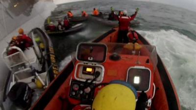 Greenpeace activists attempting to climb onto offshore platform